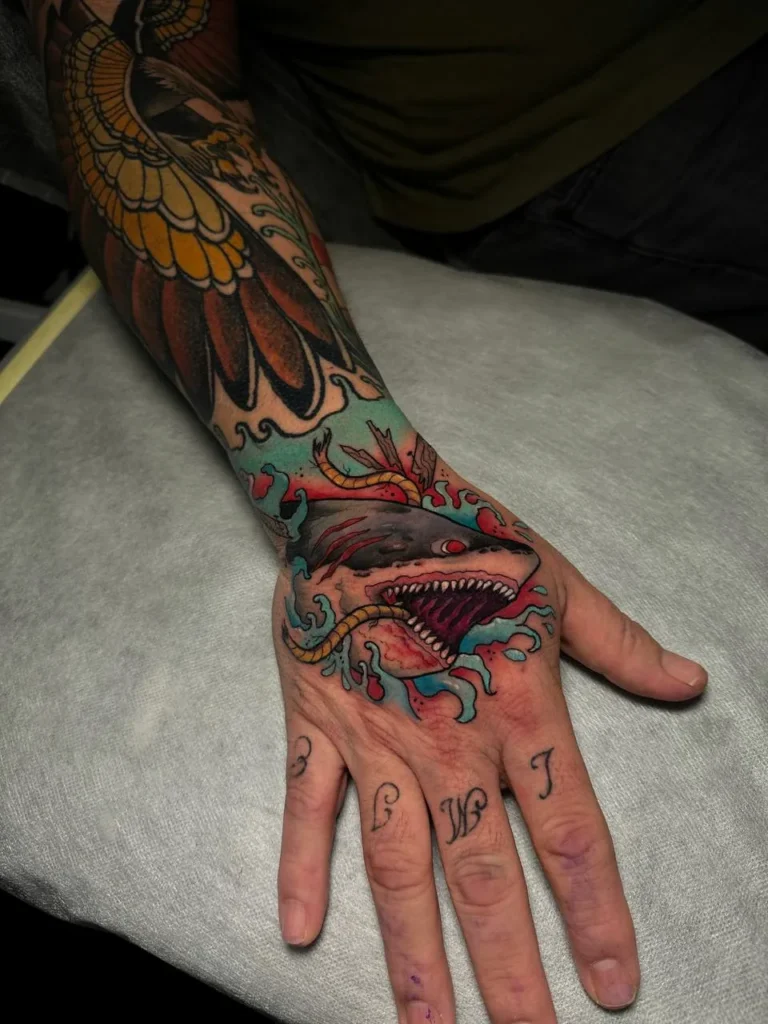 Kolorowy tatuaż rekina na dłoni - Polina Zajawa Tattoo Żary